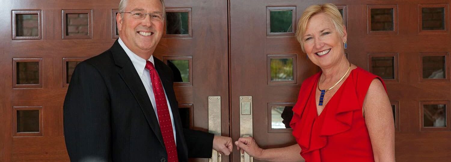 NC State Chancellor Randy Woodson and his wife Susan Woodson at the front doors of their residence, The Point