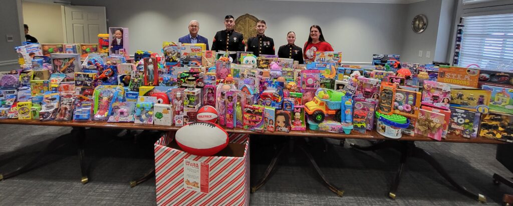 Toy drive representatives posing with 2023 donations.