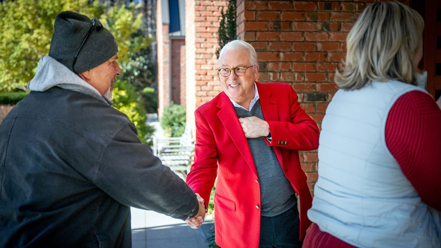 Chancellor Woodson shakes an employee's hand.